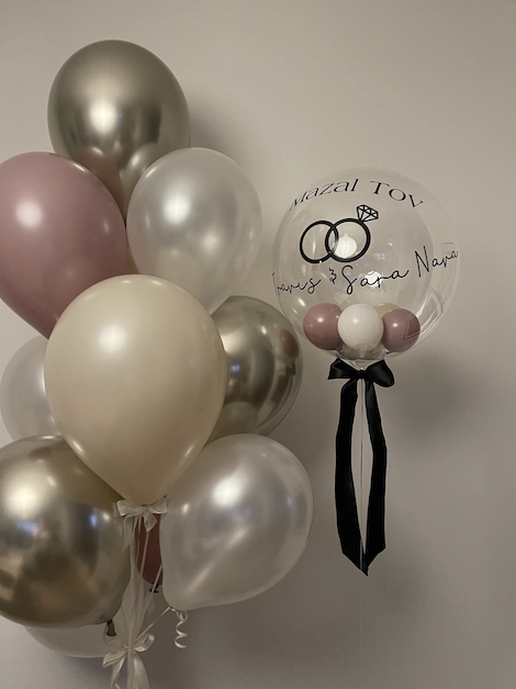 balloon clusters and one clear balloon with custom text and black ribbon