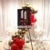 easel red gold and white balloon garland