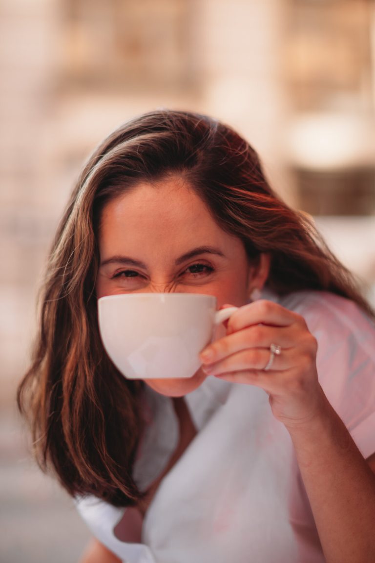Elly of Pastelly drinking from a white cup