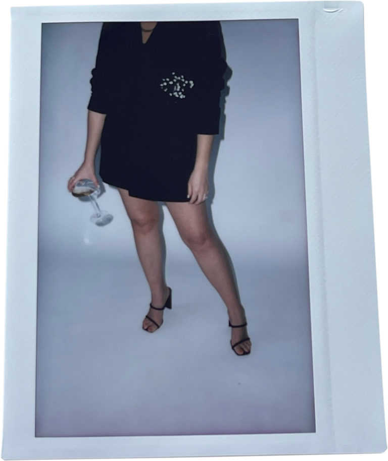 Elly of Pastelly holding sunglasses, polaroid frame