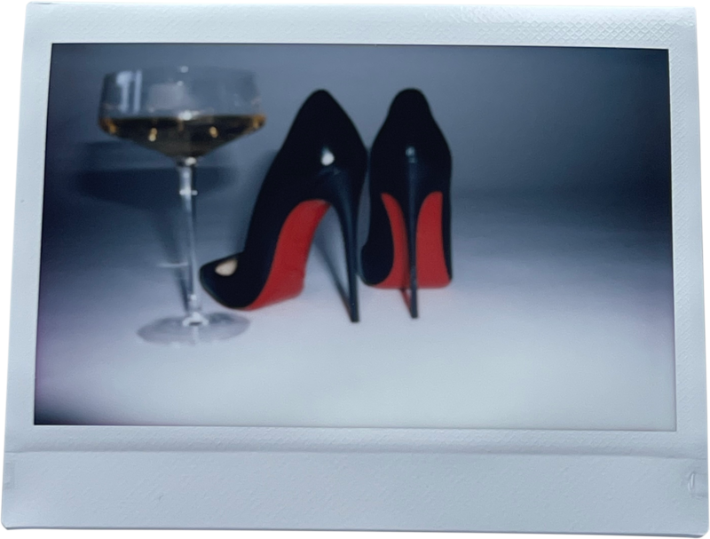 Polaroid of heels and a cocktail glass