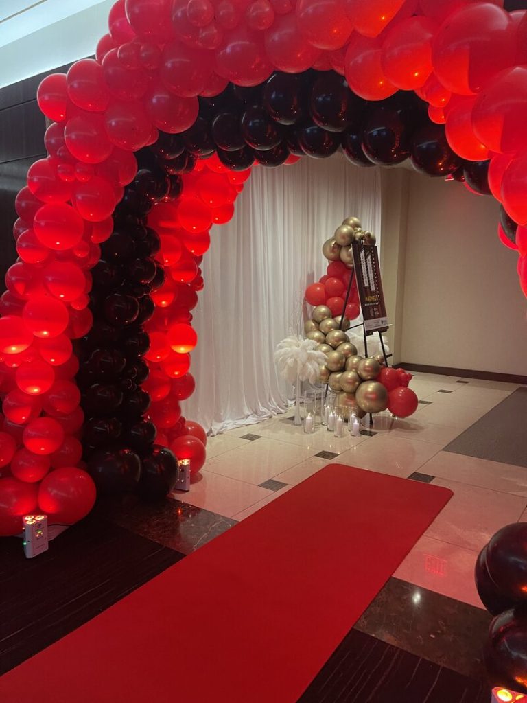 Red and black balloon arch entrance