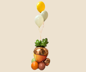 A charming fall balloon arrangement featuring stacked acorn balloons, three floating helium balloons in autumn colors, and a weighted balloon base.